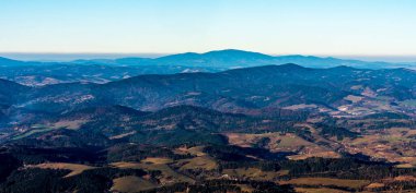Babia hora hill and nearer hlls of Oravska Magura mountains from Velky Choc hill in Chocske vrchy mountains in Slovakia during beautiful late autumn day