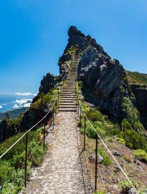 Pico do Cidrao hill with steep secured hiking trail with stairs between Pico Ruivo and Pico do Arieiro in Madeira island