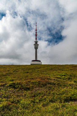 Praded hill summit with communication tower and mountain meadow in Jeseniky mountains in Czech republic