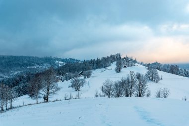 Polonya 'nın Beskid Slaski dağlarındaki Cienkow' da çoğunlukla bulutlu ve dondurucu bir kış sabahı.