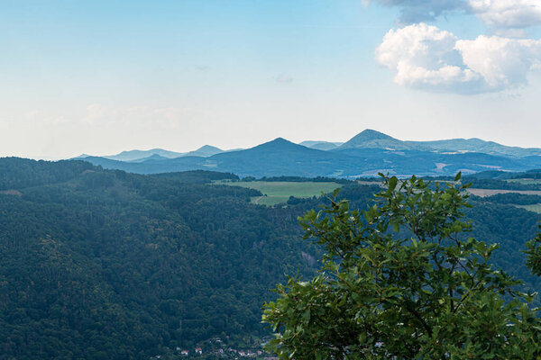 Hills of Ceske stredohori mountains from Vysoky Ostry hill near Usti nad Labem city in Czech republic during beautiful summer day