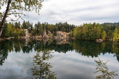 Piskovna lake in Adrspaske skaly in Czech republic during early autumn day clipart