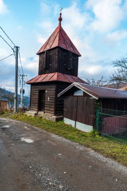 Bell tower in Kycera settlement near Cadca city in Javorniky mountains in Slovakia clipart