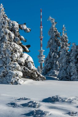 Communication tower on Praded hill in winter Jeseniky mountains in Czech republic clipart