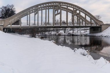 Most Sokolovskych hrdinu bridge above Olse river in Karvina city in Czech republic during winter