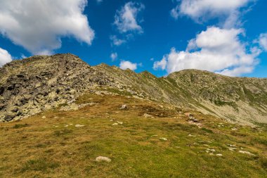 Retezat mountains with Peleaga mountain peak from Saua Custura Bucurei mountain pass in Romania during beautiful summer day