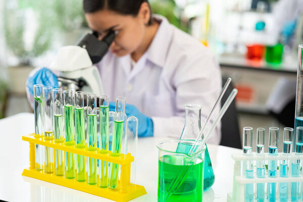 scientist looking through a microscope in a laboratory. Young scientist doing some research. scientist looking through a microscope in a laboratory. selective focus
