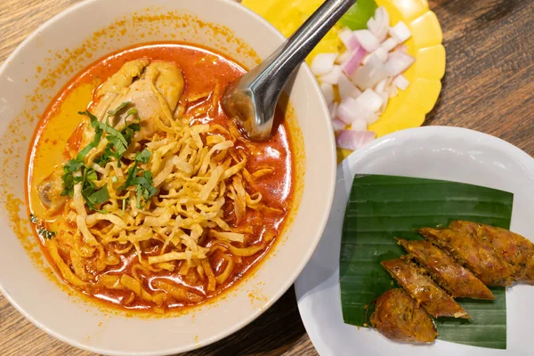 stock image Khao Soi, Thai Noodles Khao Soi, Chicken Curry with seasoning on wooden floor, Northern Thai food concept. Northern Thai Curry Noodles with Chicken