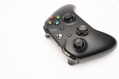 Wireless gamepad for the Xbox One, a home video game console produced by Microsoft, isolated on white background. Black Xbox game controller.
