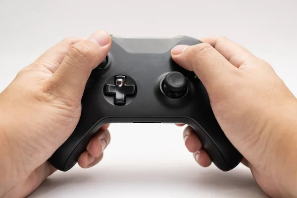 game controller with hand on white background. Black game controller isolated background.