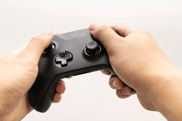 Black joystick in hands isolated on white background. Computer gaming technology play competition video game control confrontation concept. esport concept.
