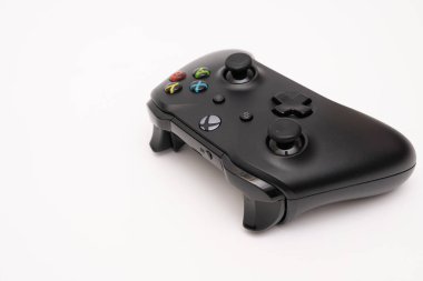 Wireless gamepad for the Xbox One, a home video game console produced by Microsoft, isolated on white background. Black Xbox game controller.