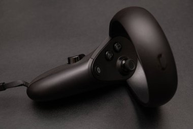 Oculus rift touch controller isolated on dark background. virtual reality wireless system created by Oculus VR, division of Facebook.