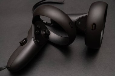 Oculus rift touch controller isolated on dark background. virtual reality wireless system created by Oculus VR, division of Facebook.