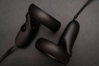 Oculus rift touch controller isolated on dark background. virtual reality wireless system created by Oculus VR, division of Facebook.