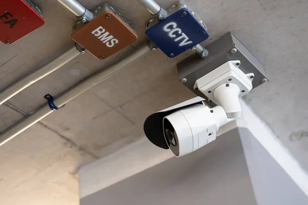 Security white CCTV (Closed-circuit television) camera in the office building. CCTV camera white on a white body.