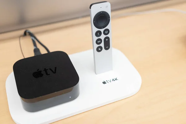 stock image Product shot of the Apple TV 4k 2022 with WiFi and Ethernet, 128Gb RAM, and with Siri Remote, on store background.