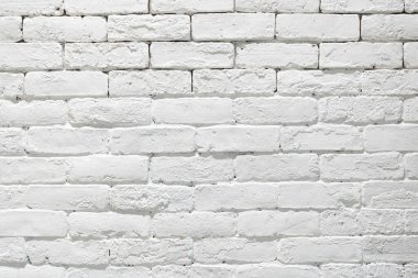 Krema ve beyaz tuğla duvar dokusu ve güneş ışığı. Tuğla işçiliği veya taş döşeme döşeme eski kaya deseni temiz beton ızgara düz olmayan tuğla dizayn yığını.