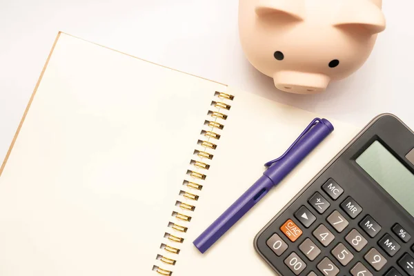 Piggy Bank Calculator Notebooks White Background Copy Space Financial Goal — Stock Photo, Image