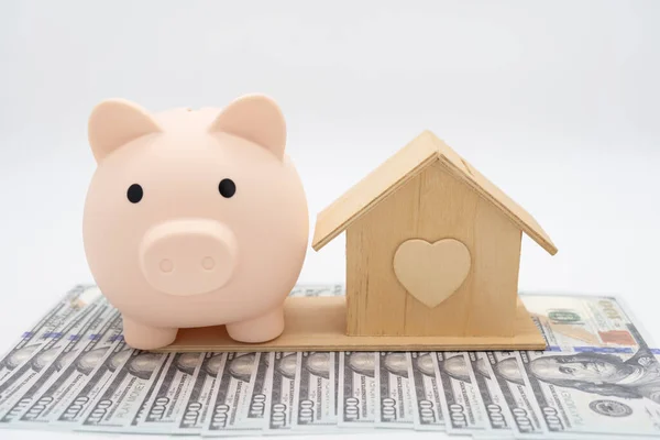 Piggy bank and house on a white background. real estate concept. concept of saving money to buy an apartment, house or other residential property.