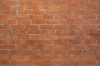 Red brick wall background in rural room. Abstract weathered texture stained old stucco light Red. Red grunge brick wall background.
