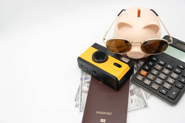 Travel planning and budget concept. Film Camera, Passport, Calculator, piggy bank and collecting money for vacation trip. Preparing for vacation.