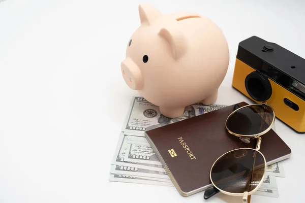 Travel planning and budget concept. Film Camera, Passport, Calculator, piggy bank, Sunglasses and collecting money for vacation trip. Preparing for vacation.