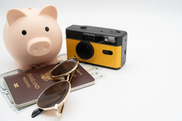 Travel planning and budget concept. Film Camera, Passport, Calculator, piggy bank and collecting money for vacation trip. Preparing for vacation.