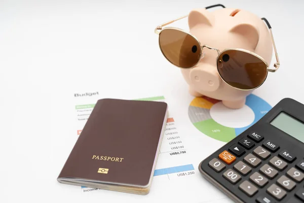 Budget management for vacation concept. Passport, piggy bank and calculator for vacation trip and budget graph. Preparing for vacation.