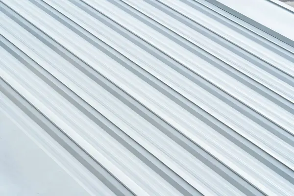 stock image Aluminium Metal sheet roof. Metal aluminum silver corrugated stripe sheet wall background. Aluminium Metal sheet roof industrial building roof.