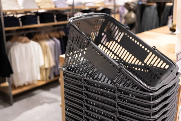 Stack of gray shopping basket in a clothes store. Shopping basket is used to carry the shopping items in a supermarket, mini market, store, or department store.