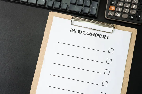 Blank checklist paper during safety audit and risk verification. safety checklist form on the desk.