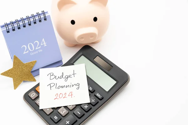 Budget Planning 2024 text message by hand writing on paper note, Calendar 2024, Golden Star, Calculator and Piggy bank. Budget planning concept.