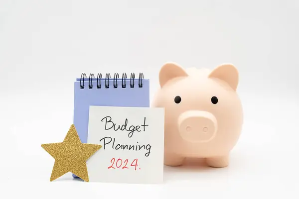 Budget Planning 2024 text message by hand writing on paper note, Calendar, Golden Star and Piggy bank. Budget planning concept.