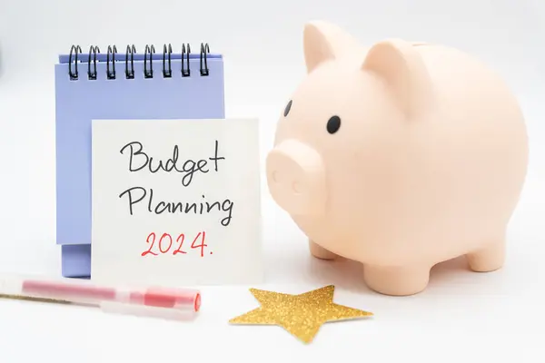 Budget Planning 2024 text message by hand writing on paper note, Calendar, Golden Star and Piggy bank. Budget planning concept.