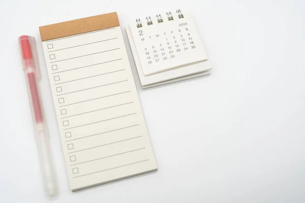 Blank Check list or Empty small notepad with checkbox and Simple desk calendar for FEB 2024. Blank checklist for text. Copy Space.