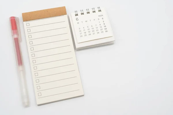 Blank Check list or Empty small notepad with checkbox and Simple desk calendar for JUNE 2024. Blank checklist for text. Copy Space.