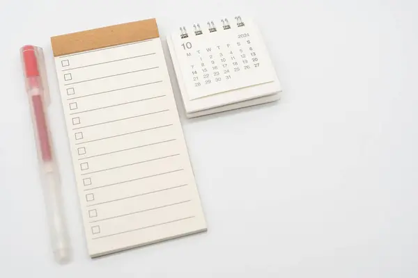 Blank Check list or Empty small notepad with checkbox and Simple desk calendar for OCTOBER 2024. Blank checklist for text. Copy Space.