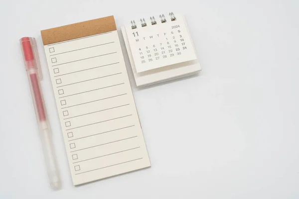 Blank Check list or Empty small notepad with checkbox and Simple desk calendar for NOVEMBER 2024. Blank checklist for text. Copy Space.