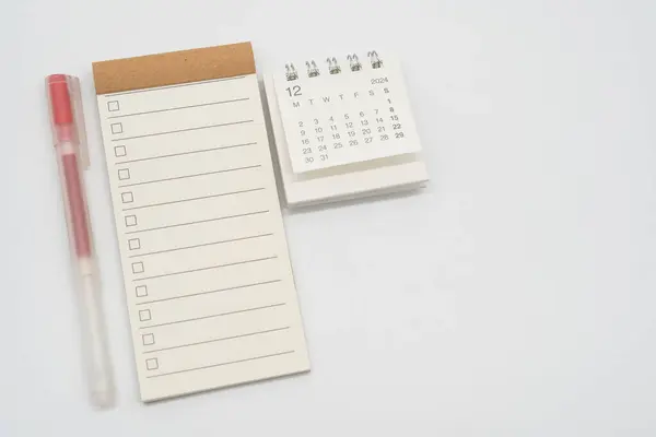 Blank Check list or Empty small notepad with checkbox and Simple desk calendar for DECEMBER 2024. Blank checklist for text. Copy Space.