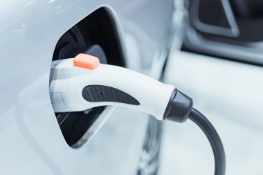 Elektrik kablosu tıkanmış bir şekilde şarj istasyonundaki EV Car veya Electric Car. Yeşil enerji ve eko enerji üretimi kavramında elektrikli araba şarj istasyonu.