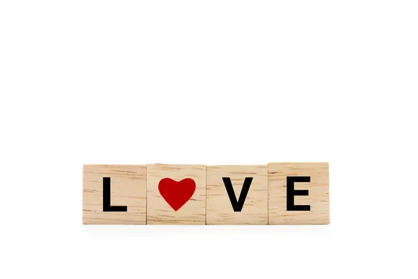 stock image Hand place wooden blocks with LOVE text and red heart isolated on white background. Love symbol with copy space and clipping path.