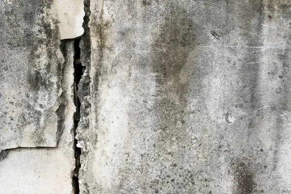 stock image house broken. concrete crack. Water damage building interior. large crack white concrete wall