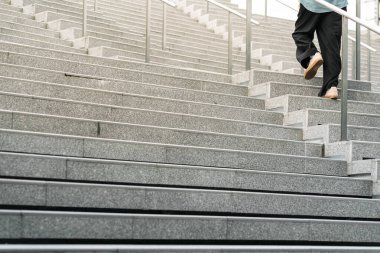 Soyut merdivenler siyah beyaz, soyut basamaklar, şehirde merdivenler. Geniş, pürüzsüz beton merdivenleri ve parlak paslanmaz çelik tırabzanları olan modern bir merdiven..