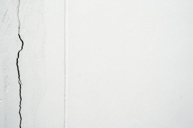 house broken. concrete crack. Water damage building interior. large crack white concrete wall