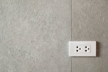 Modern Beton Duvarı 'ndaki elektrik prizi ve kopyalama alanı. Duvarın nötr tonları geniş kopya alanı sağlar, bu resim arka plan ve ev geliştirme projeleri için idealdir.