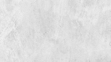 Açık gri beton bir duvarın desenli yakın çekimi yüzeyde çaprazlama uzanan ince bir çatlak içeriyor..