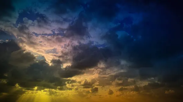 stock image Golden and blue skies blend with dramatic clouds, creating a breathtaking 4K background ideal for wallpapers, banners, and natural scene backdrops