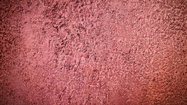Yumuşak ve yıpranmış görünümlü, pembe desenli beton bir yüzey. Yaratıcı, modern ve sanatsal tasarımlar için mükemmel, cesur ama ince bir görsel etki ekleyerek