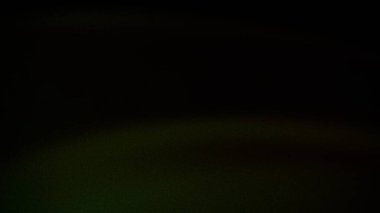 İnce yeşil ve siyah tonlara sahip koyu soyut arkaplan, taneli bir doku ve yumuşak geçişler, zarif ve modern tasarımlar için idealdir.